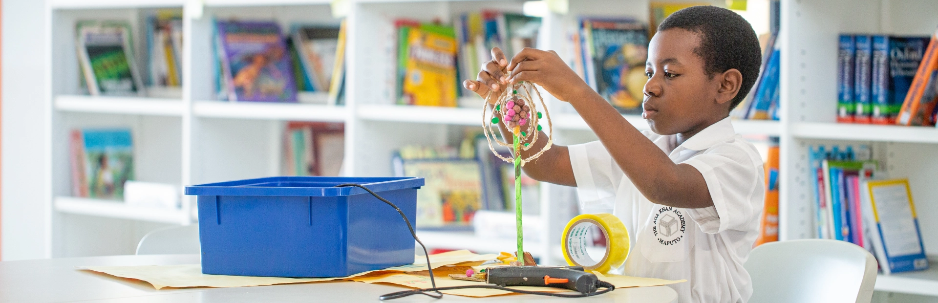 AKA Maputo student works on a project in the library